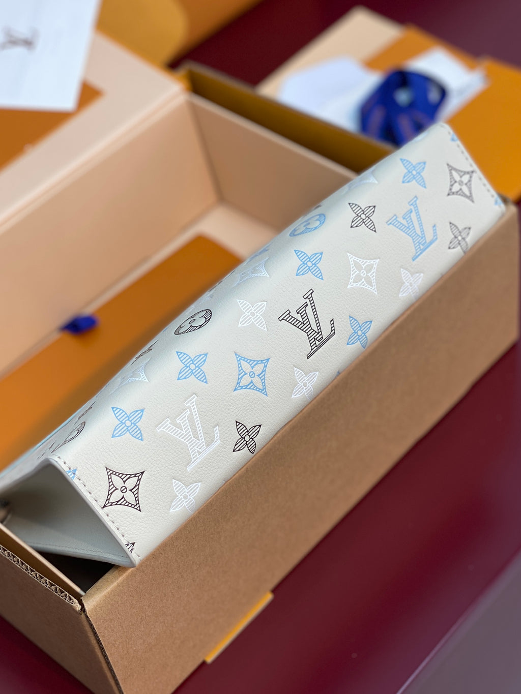 Light blue and white monogram Louis Vuitton pouch with top zipper and short strap
