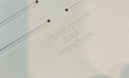 Embossed Louis Vuitton Paris made in France label on light monogram canvas