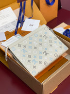 Louis Vuitton top-zip clutch bag in light cream with blue monogram pattern