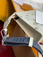 Louis Vuitton small bag corner view, white monogram pattern, blue strap with metal clip