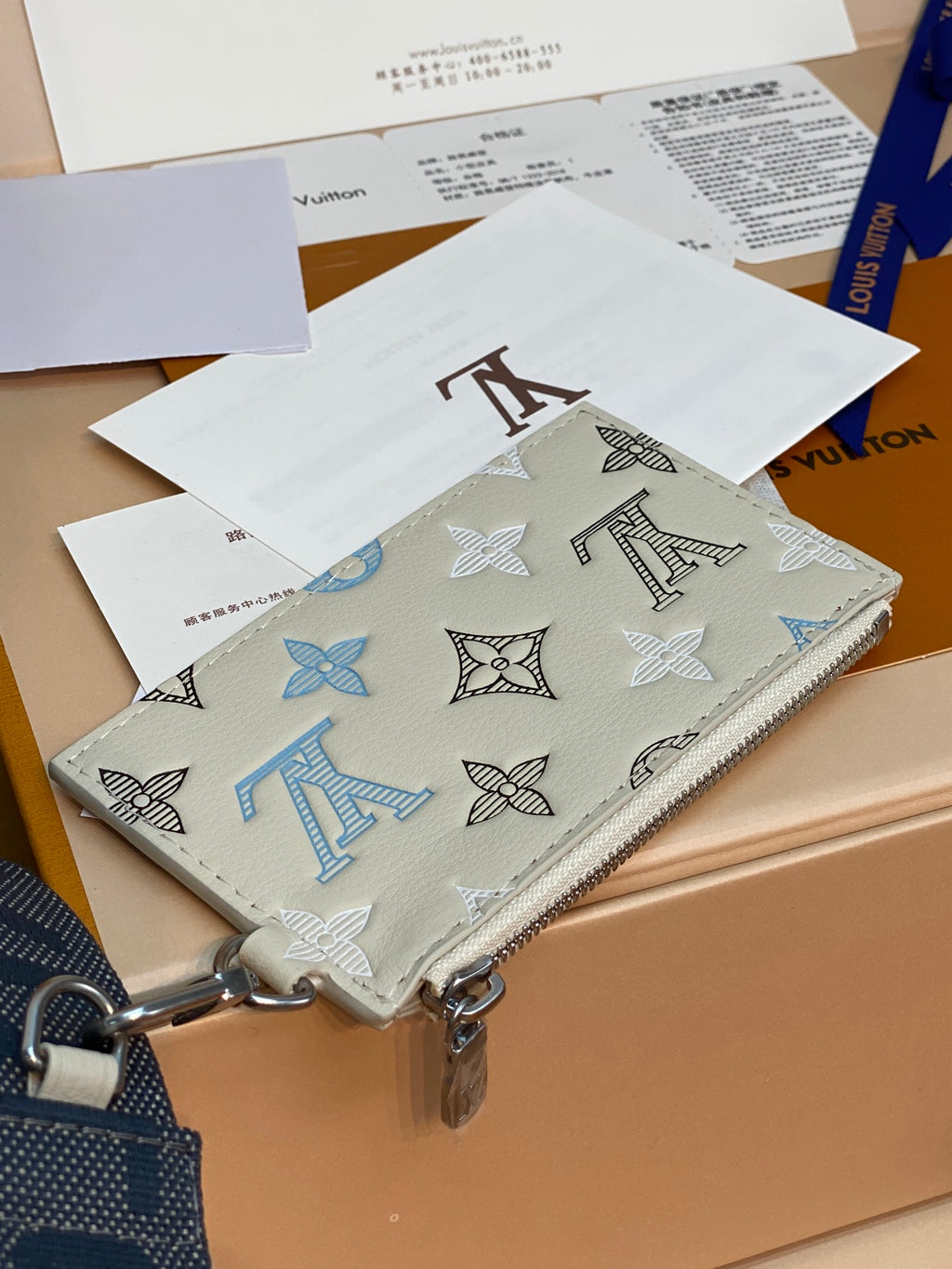Louis Vuitton small zip bag with multicolor monogram pattern, white exterior and metal hardware