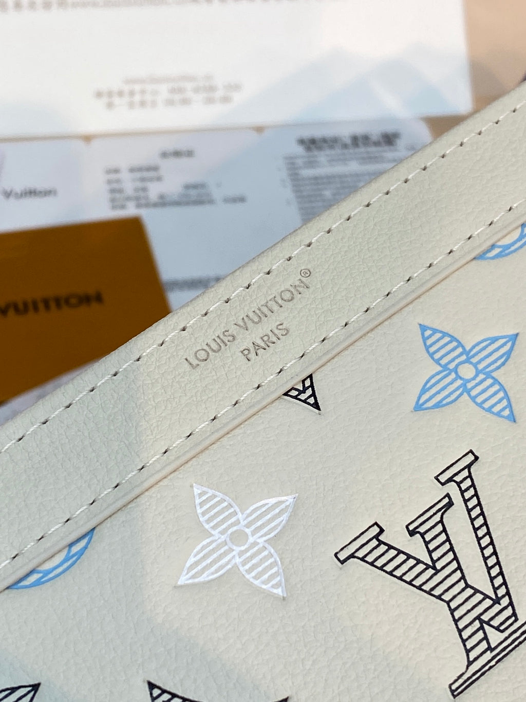 Louis Vuitton small bag: beige leather with blue logo print and stitched trim