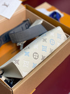 Louis Vuitton small bag, white monogram pattern pouch with blue strap and zipper pocket