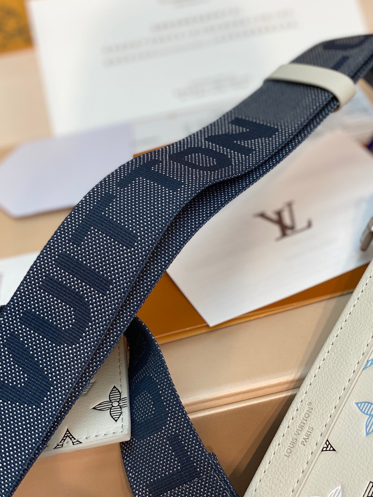 Louis Vuitton small bag: navy jacquard strap with repeating LV pattern and emblem