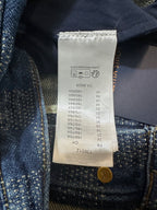 Denim pants size and care tag with gold button at waistband