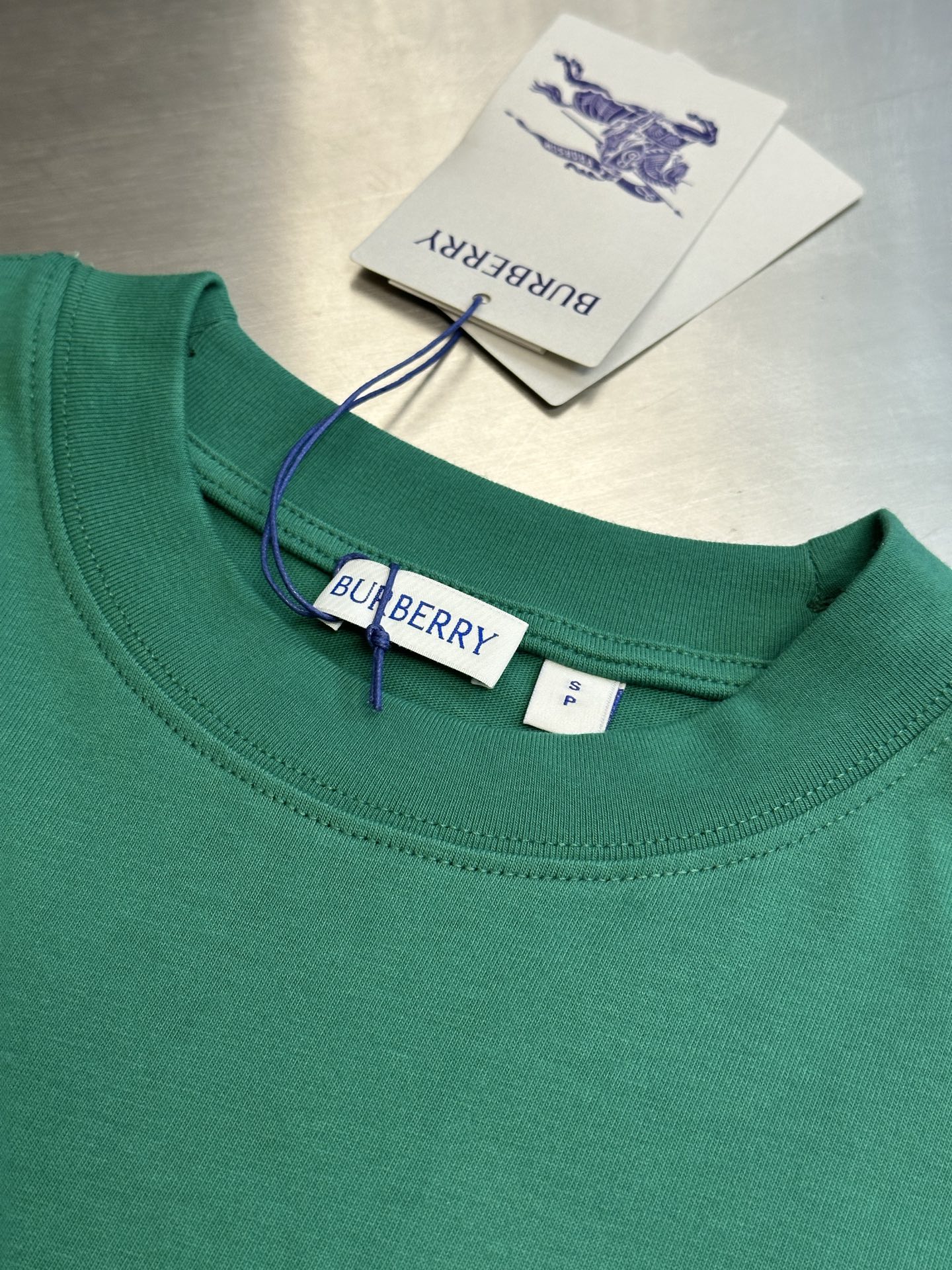 Green crewneck short-sleeve T-shirt with Burberry label and neck tag