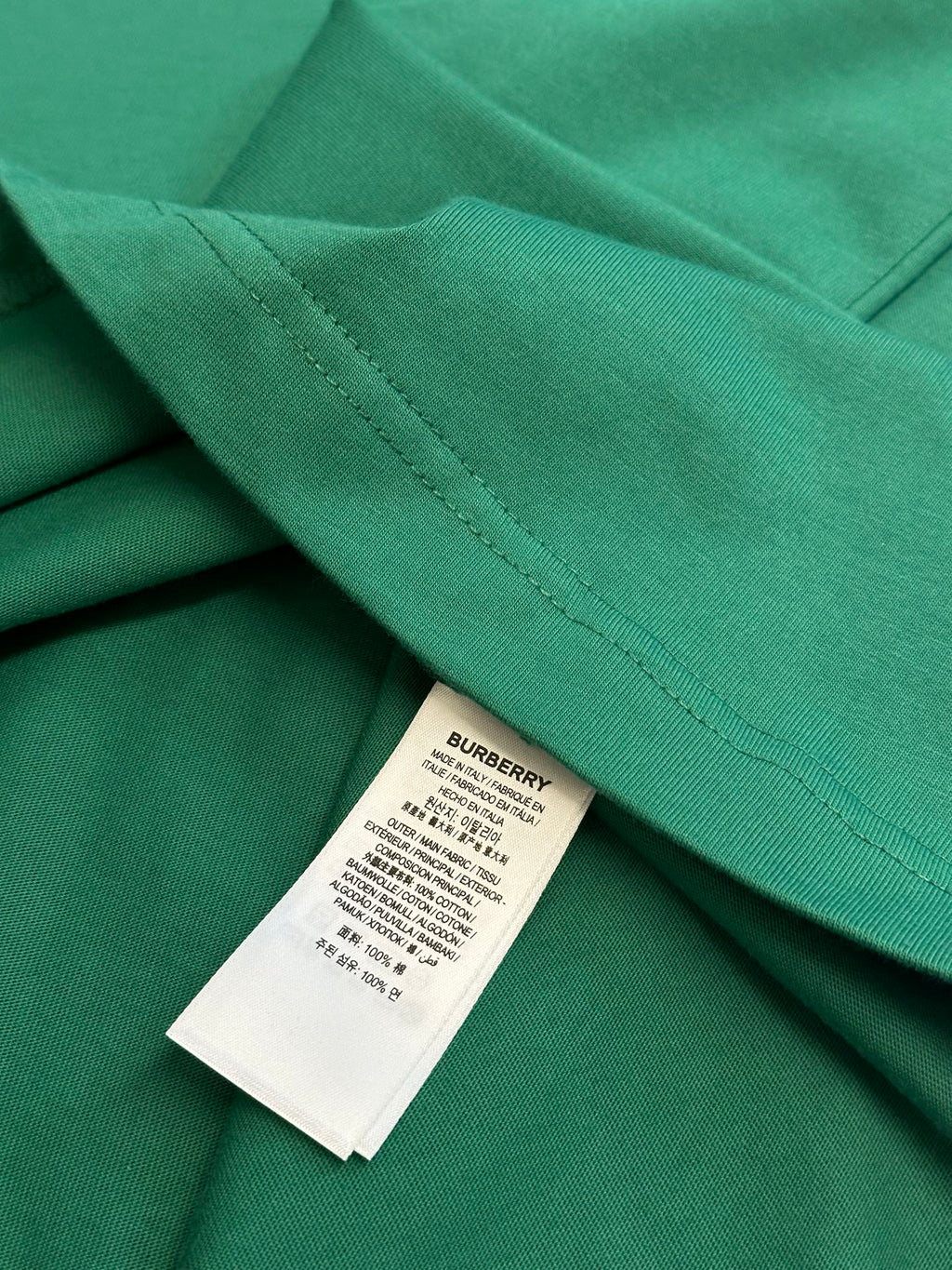 Green short-sleeve T-shirt with stitched hem and inner label tag