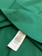 Green short-sleeve T-shirt with stitched hem and inner label tag