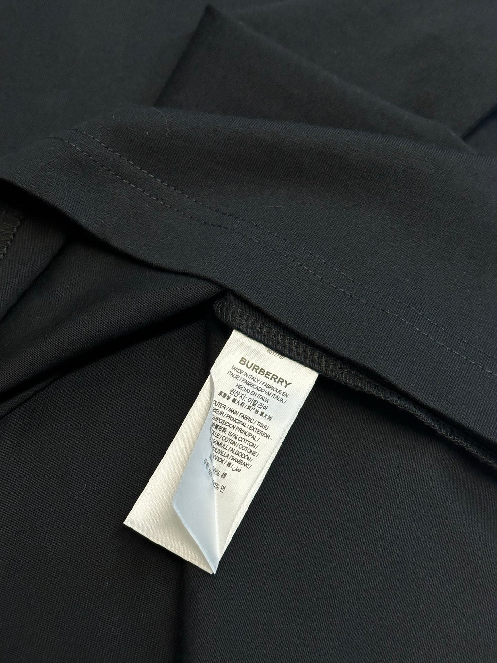 Black short-sleeve T-shirt with stitched hem and interior care label