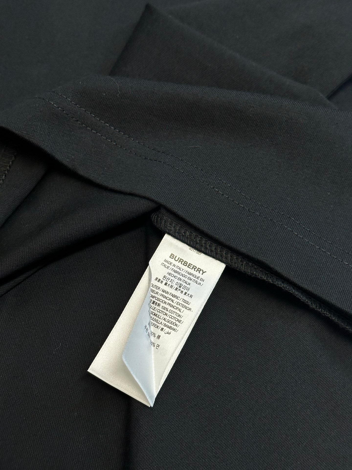 Black short-sleeve T-shirt with stitched hem and interior care label