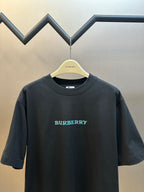 Black short-sleeve T-shirt with Burberry logo text in teal on front