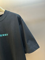 Black T-shirt sleeve with embroidered Burberry logo in teal