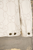 Gucci long-sleeve jacket hem with dark snap buttons and monogram pattern