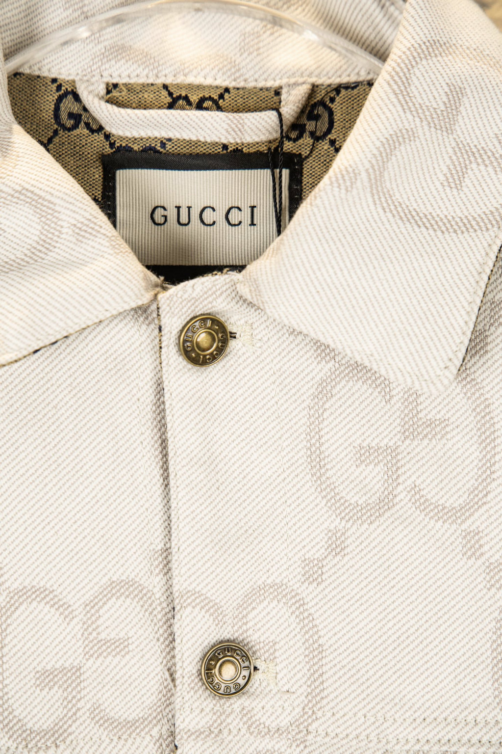 Gucci GG-print white jacket close-up of collar and gold-tone buttons