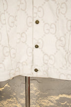 Gucci long-sleeve jacket front with three dark snap buttons and monogram texture