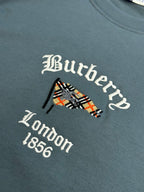 Embroidered Burberry London 1856 logo on blue short-sleeve T-shirt chest