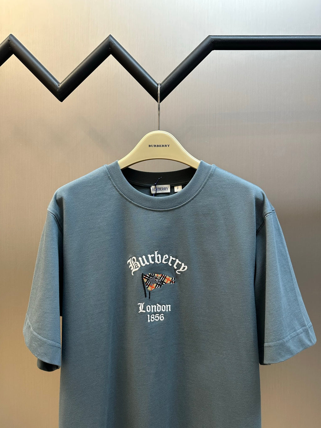 Blue short-sleeve T-shirt with embroidered “Burberry London 1856” graphic on chest