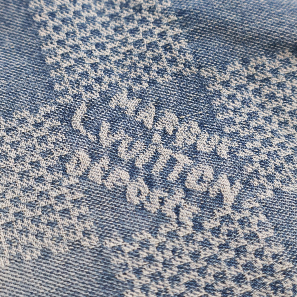 Embroidered blue floral pattern on light denim