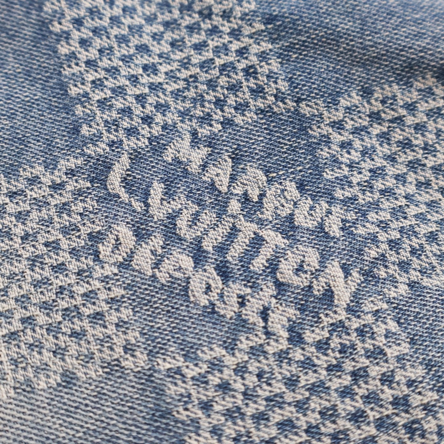 Embroidered blue floral pattern on light denim