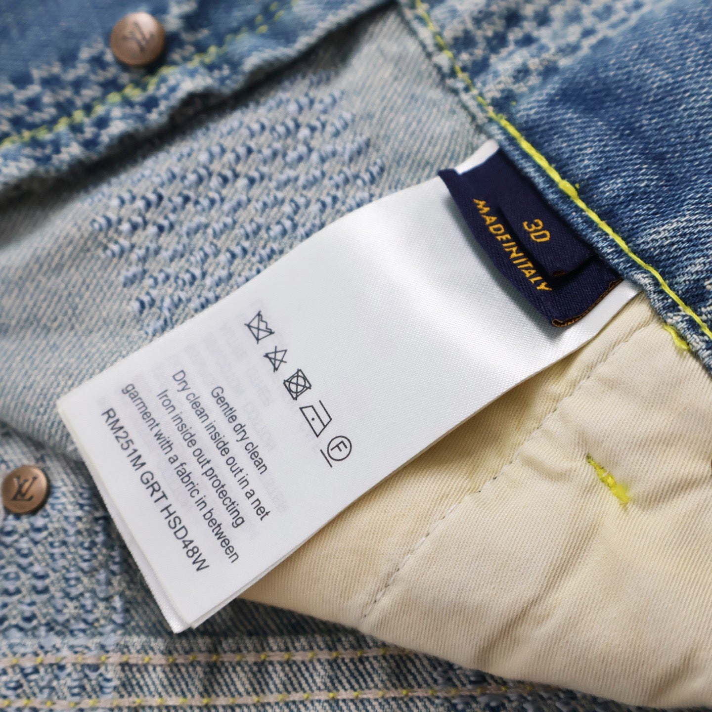 Interior care label inside denim shorts with fabric care icons