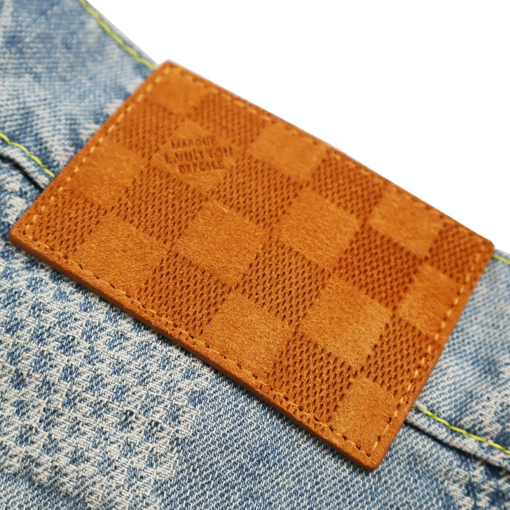 Orange checkered leather patch label on denim