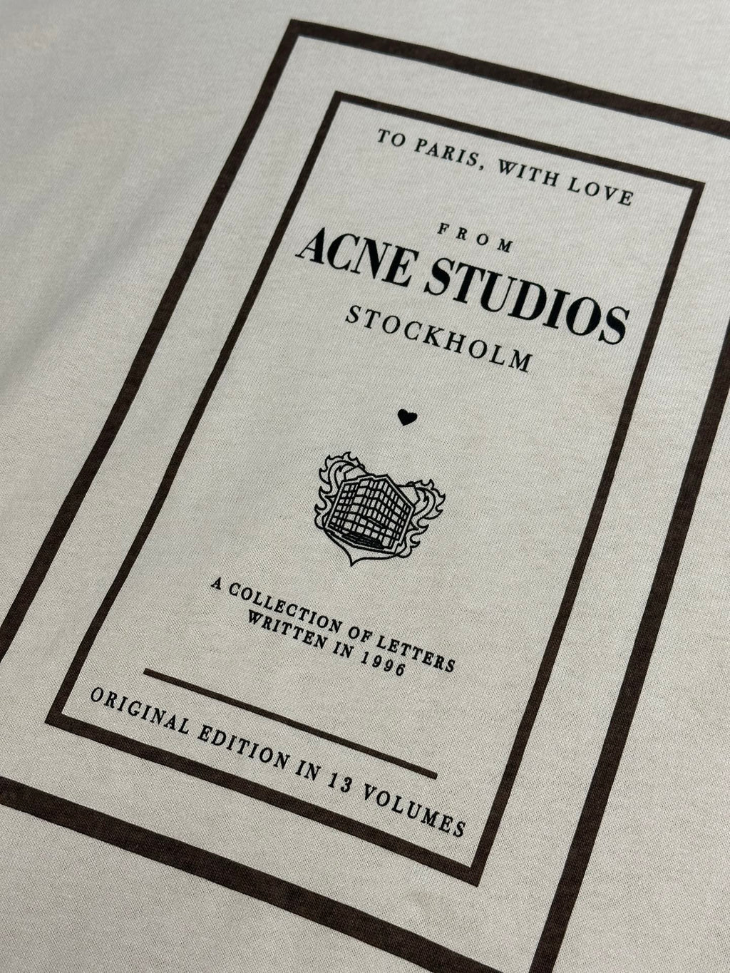 Acne Studios logo graphic on cream T-shirt, framed print