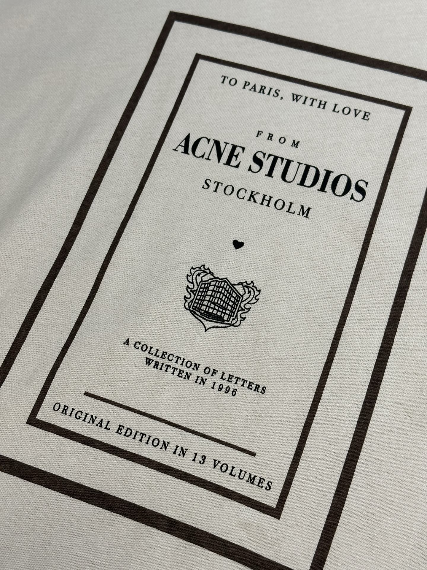 Acne Studios logo graphic on cream T-shirt, framed print