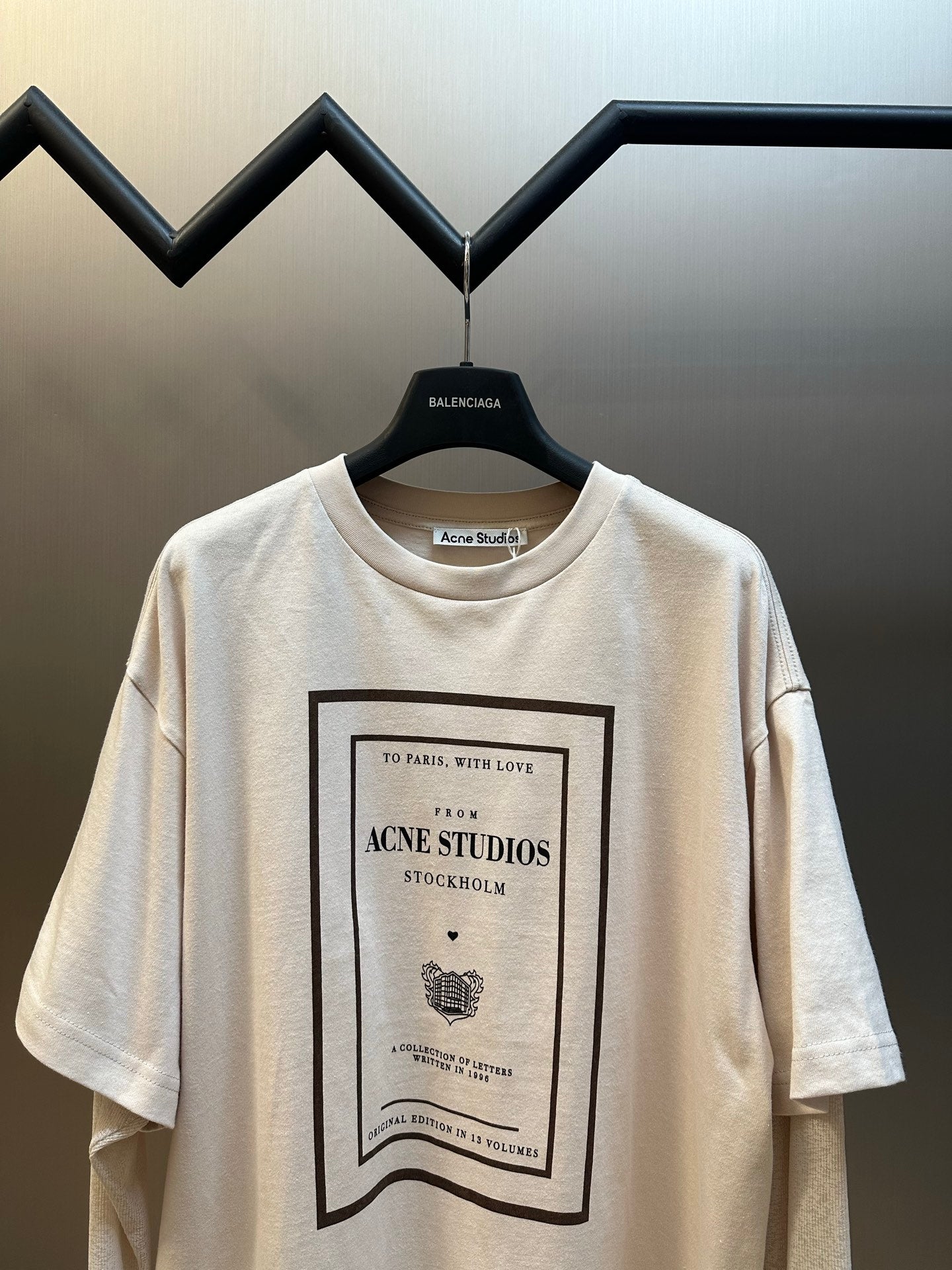 Cream short-sleeve T-shirt with centered framed Acne Studios logo graphic