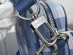 Louis Vuitton check bag hardware detail: metal rings and blue leather strap near zipper