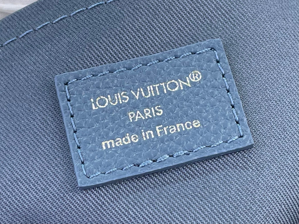 Louis Vuitton label patch on blue fabric: “LOUIS VUITTON PARIS made in France”