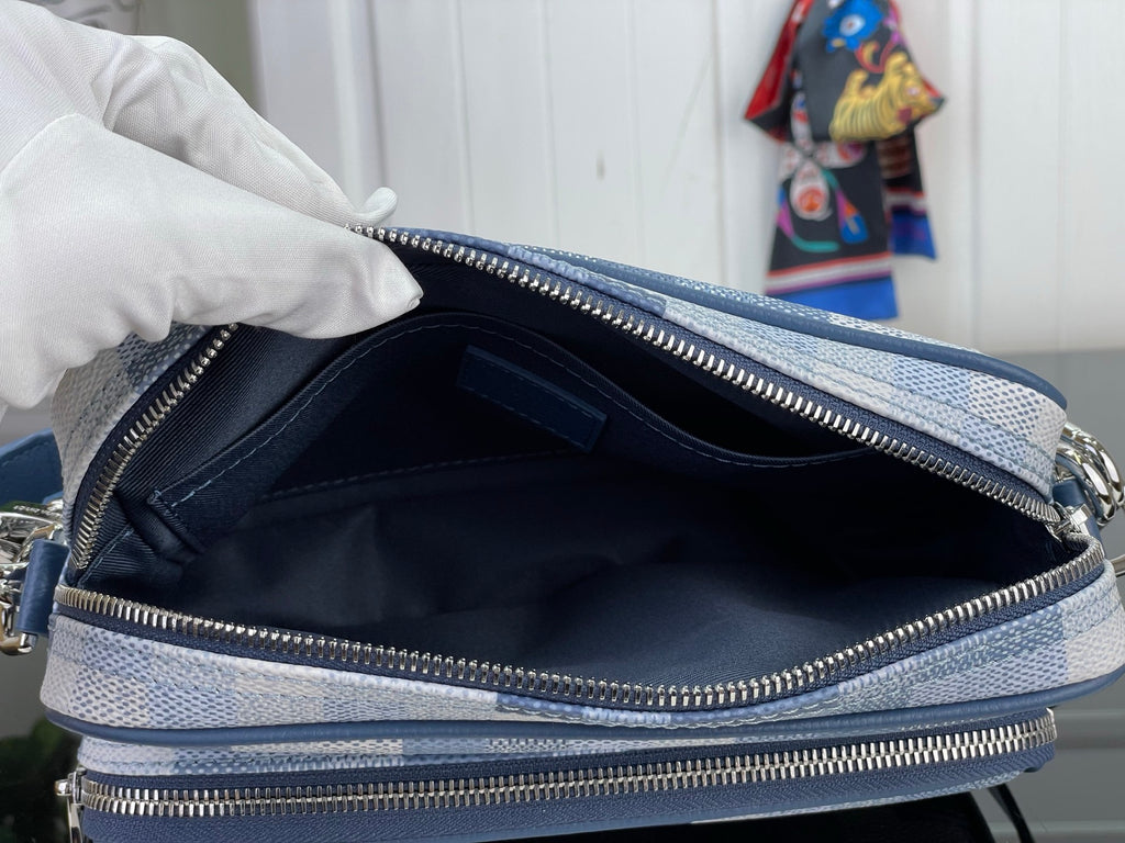 Louis Vuitton check bag open view showing navy fabric interior and double zip pockets