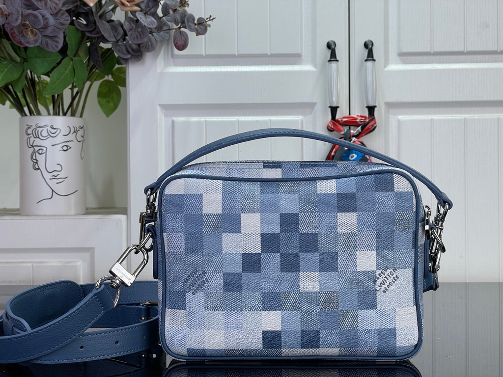 Louis Vuitton check crossbody bag with blue panels, top zip, and side strap loops