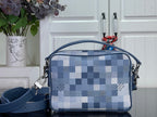 Louis Vuitton check crossbody bag with blue panels, top zip, and side strap loops