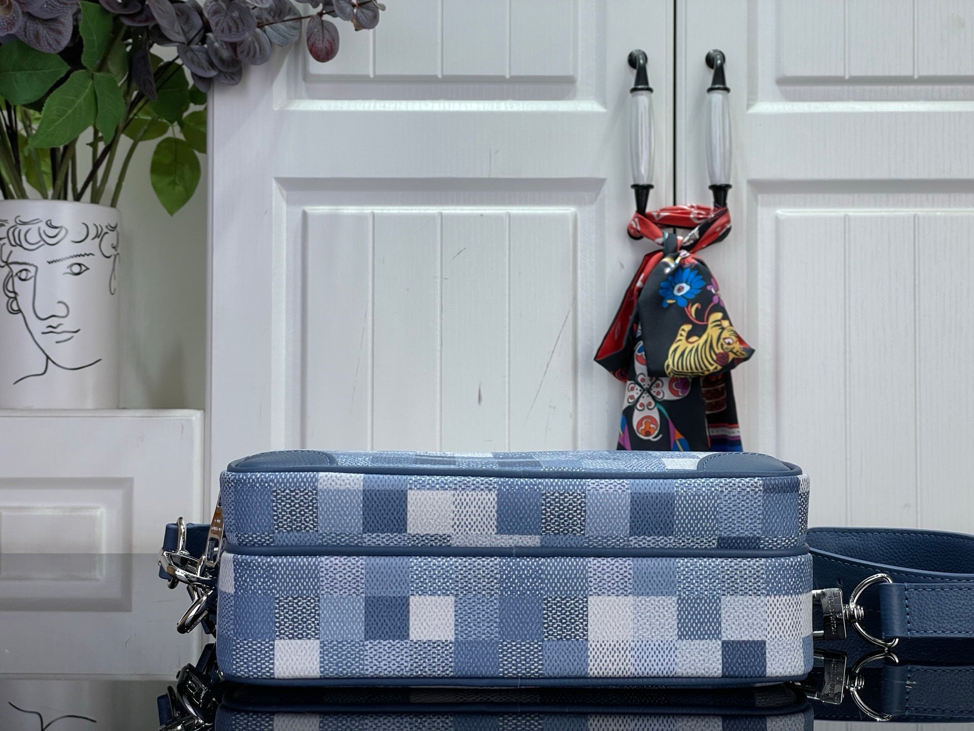 Louis Vuitton check mini bag in blue with top handle, layered zippers, and charm