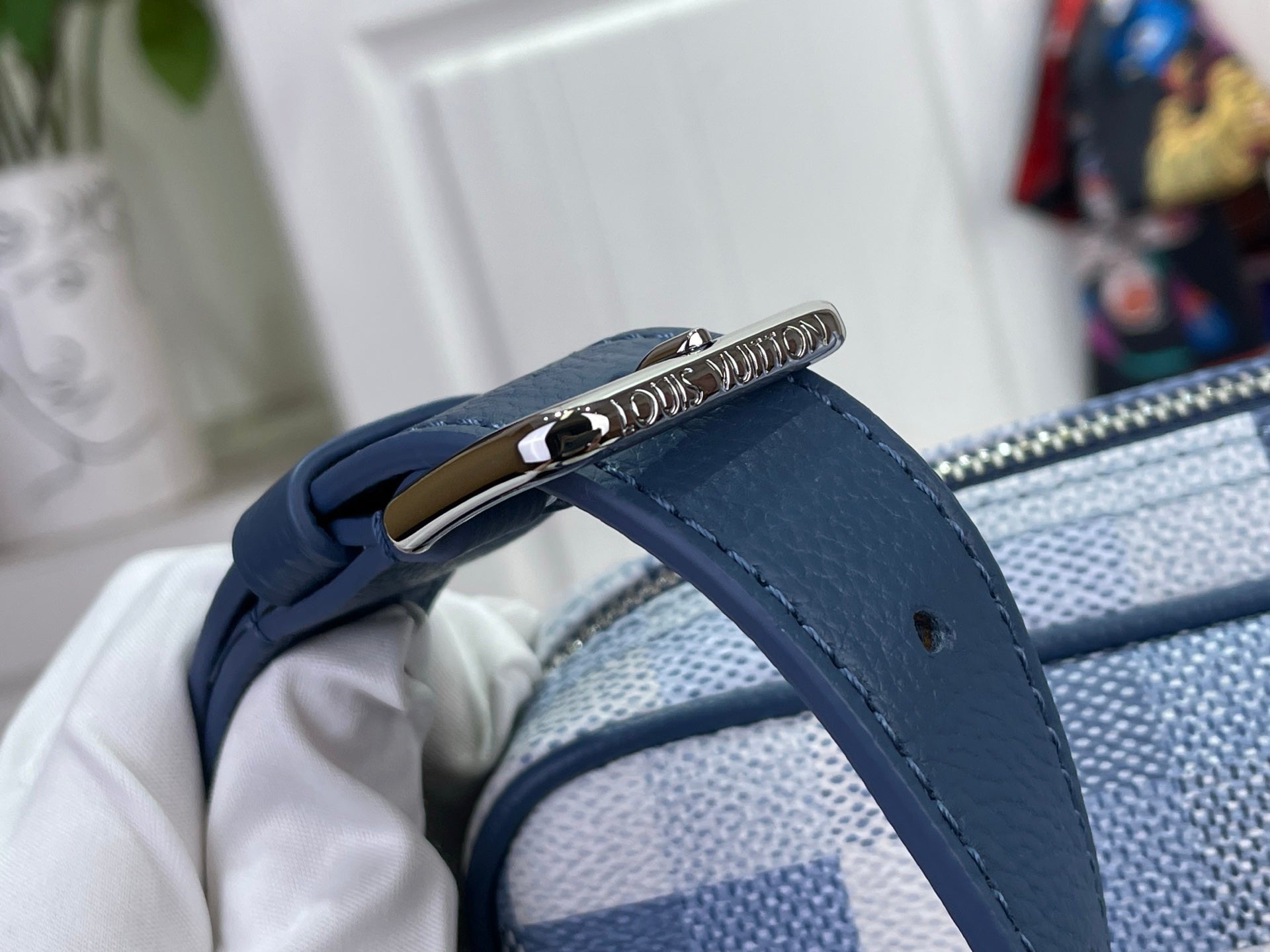 Louis Vuitton check bag strap end with blue leather tab and metal loop connector