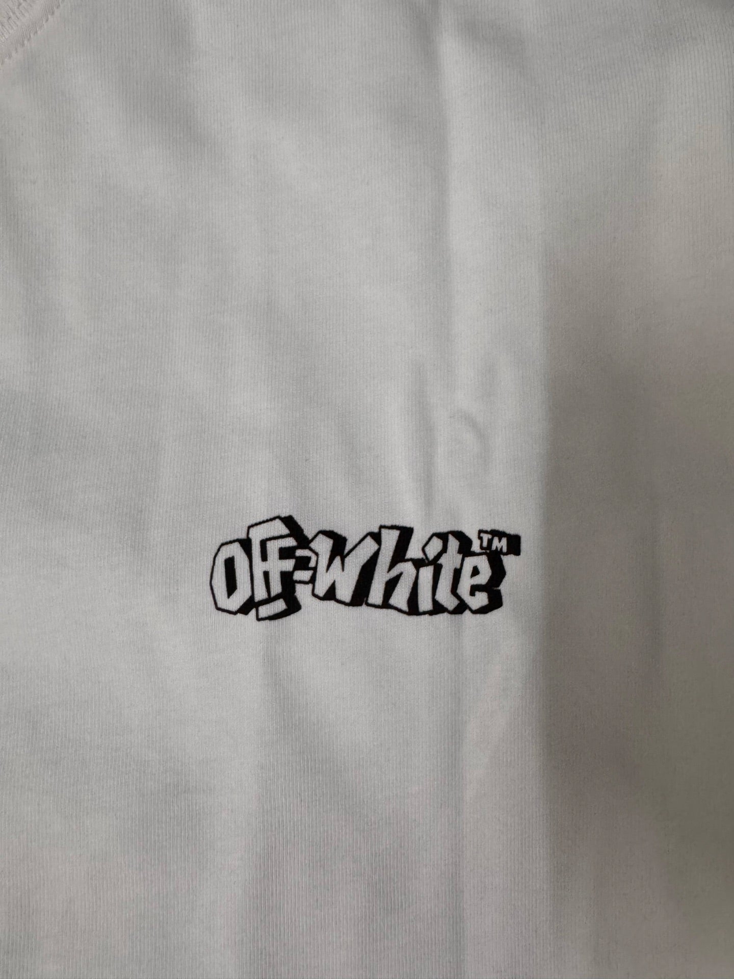 Off White logo on white crew-neck T-shirt chest, black text graphic