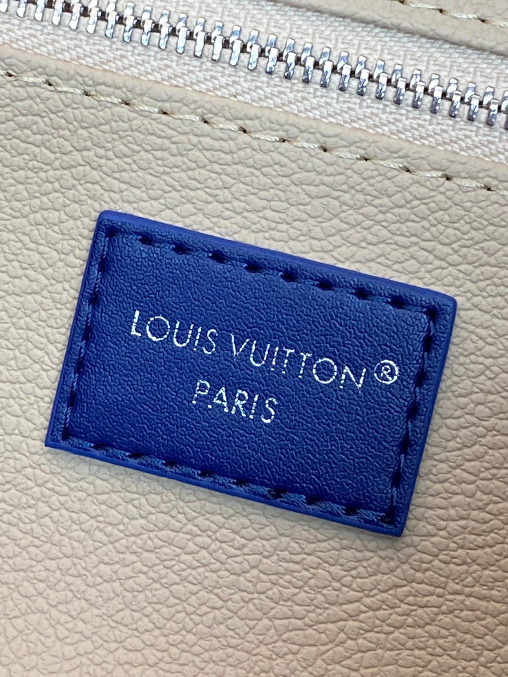 Louis Vuitton Paris leather tag in blue on light interior lining