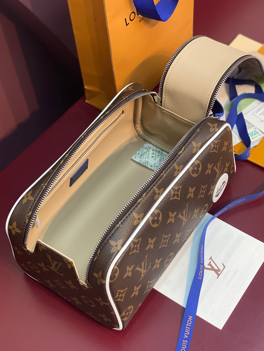 Louis Vuitton belt bag open showing tan interior and zipper with blue accents