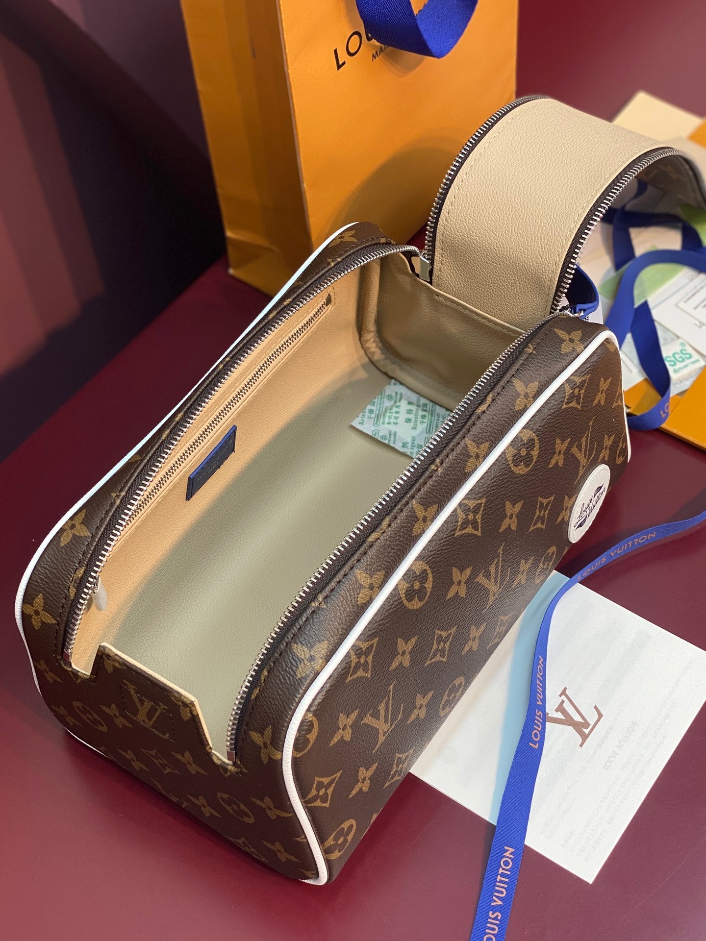 Louis Vuitton belt bag open showing tan interior and zipper with blue accents