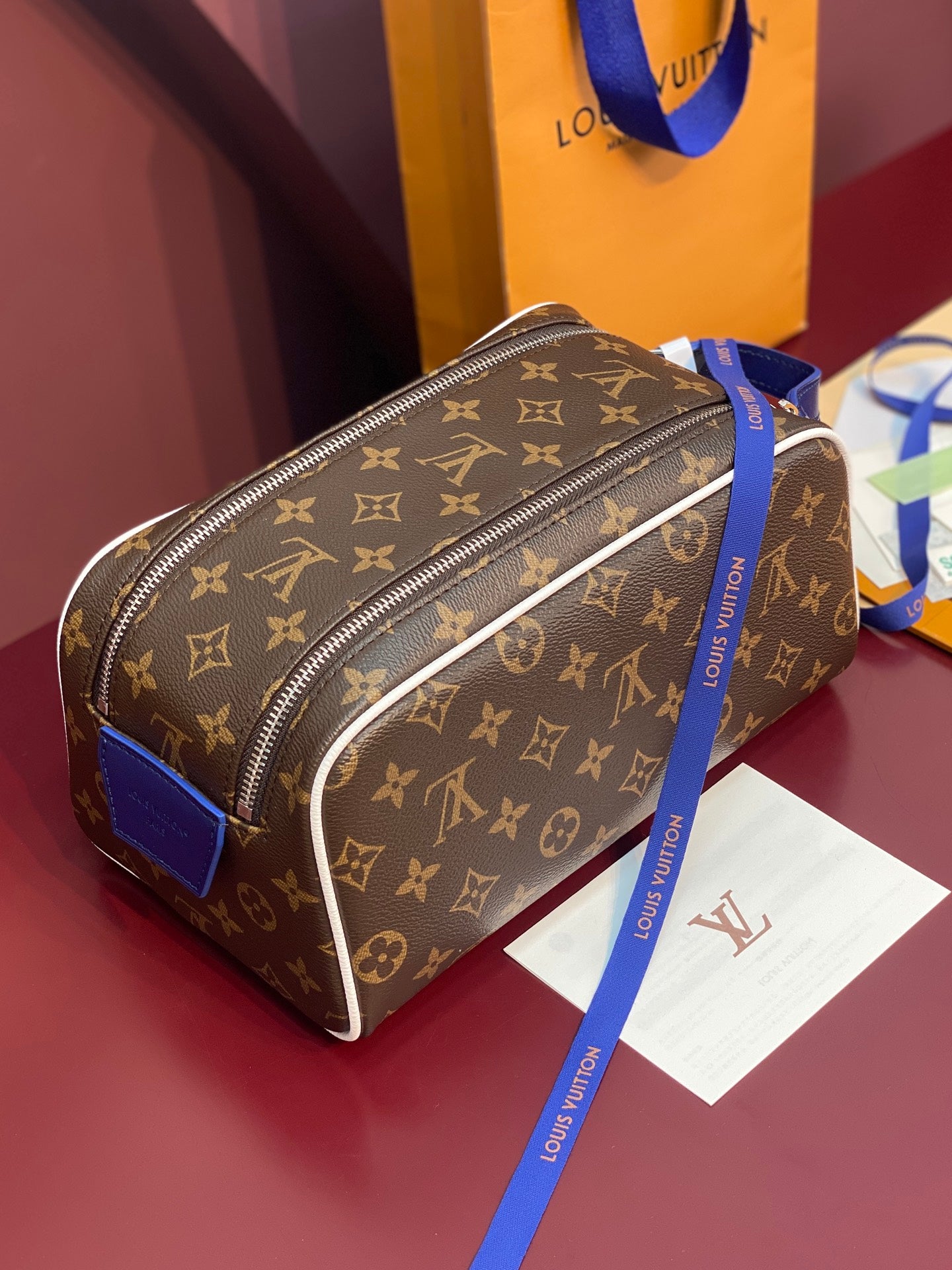 Louis Vuitton monogram canvas belt bag with blue strap and silver-tone zip