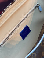 Louis Vuitton belt bag leather patch and silver zipper on tan interior lining