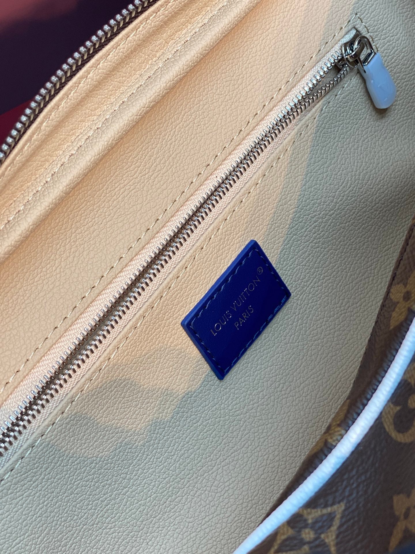 Louis Vuitton belt bag leather patch and silver zipper on tan interior lining