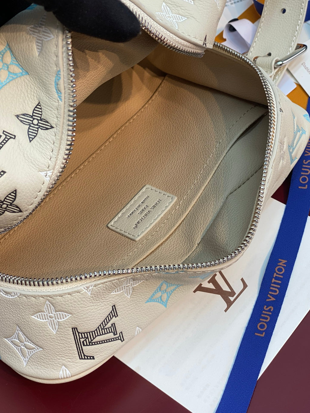 Louis Vuitton toiletry bag open with interior label patch on light beige lining