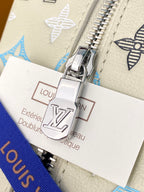 Louis Vuitton lock hardware with care card reading 'Extérieur Cuir de veau' on beige