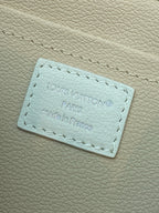 Louis Vuitton interior leather label patch with 'Paris' text on light beige
