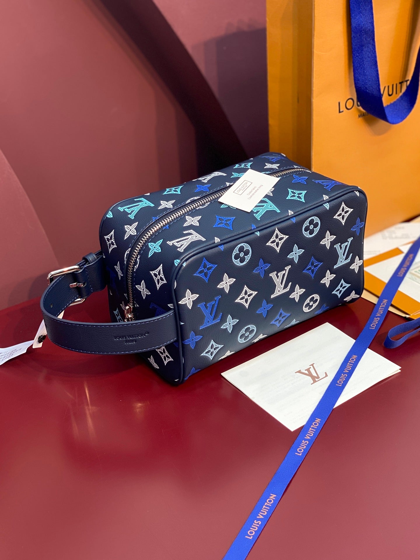Louis Vuitton multi-color monogram crossbody bag with navy trim and zip closure