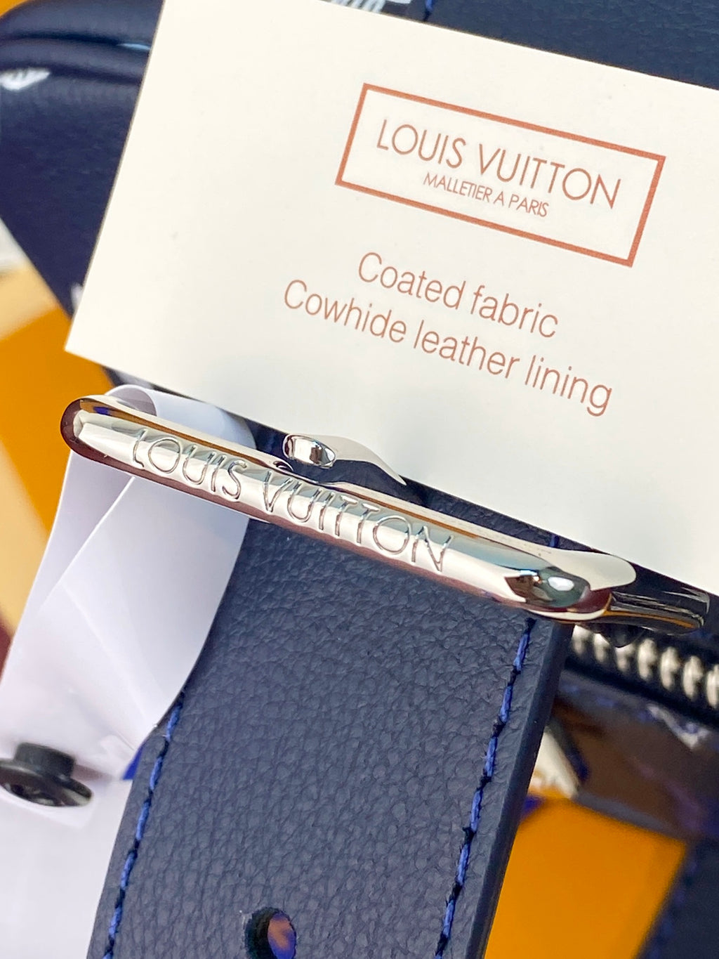 Louis Vuitton coated fabric cowhide leather lining tag with metal clasp on bag