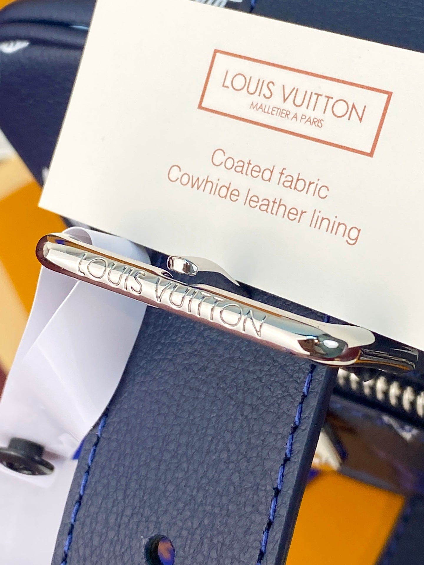 Louis Vuitton coated fabric cowhide leather lining tag with metal clasp on bag