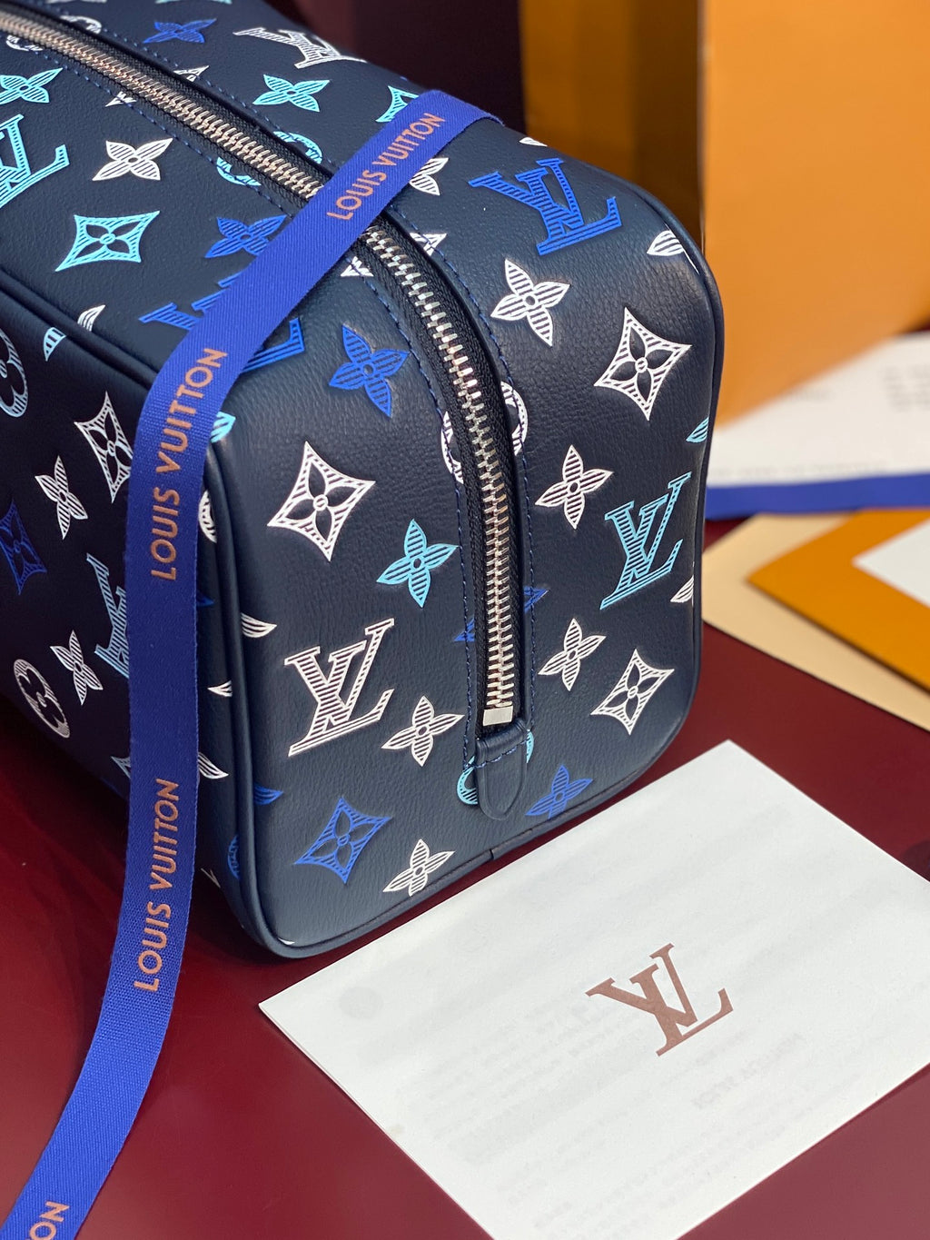 Louis Vuitton multi-color monogram bag end view with silver-tone top zipper