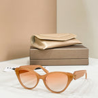 Amber cat-eye glasses with tinted lenses and gold-tone logo hinge